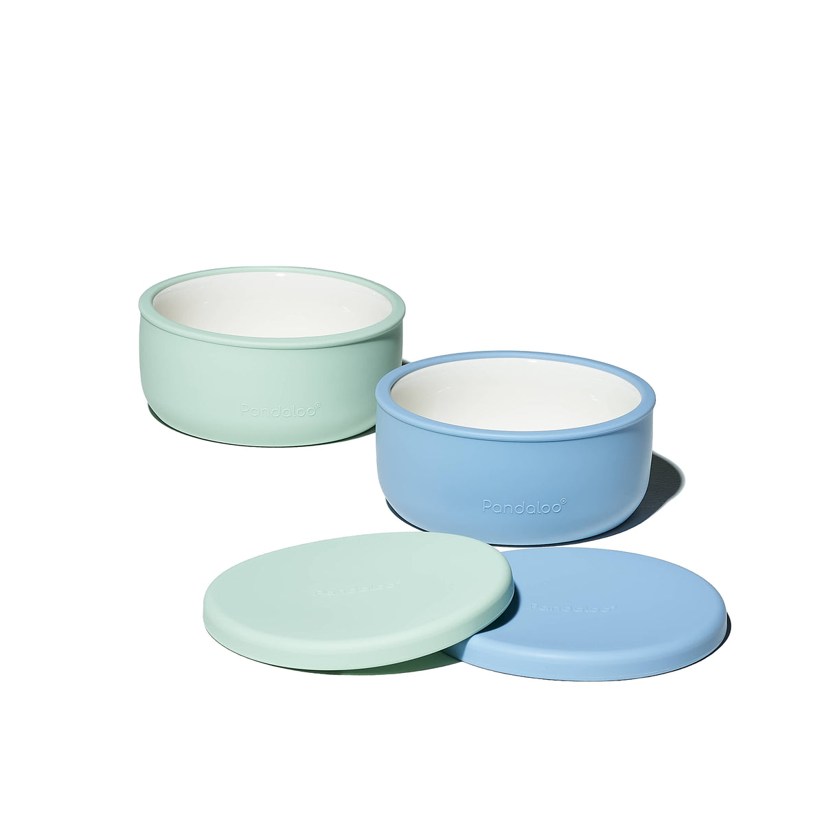 Two Pandaloo Kids porcelain bowls in Baby Blue and Sweet Sage with silicone lids