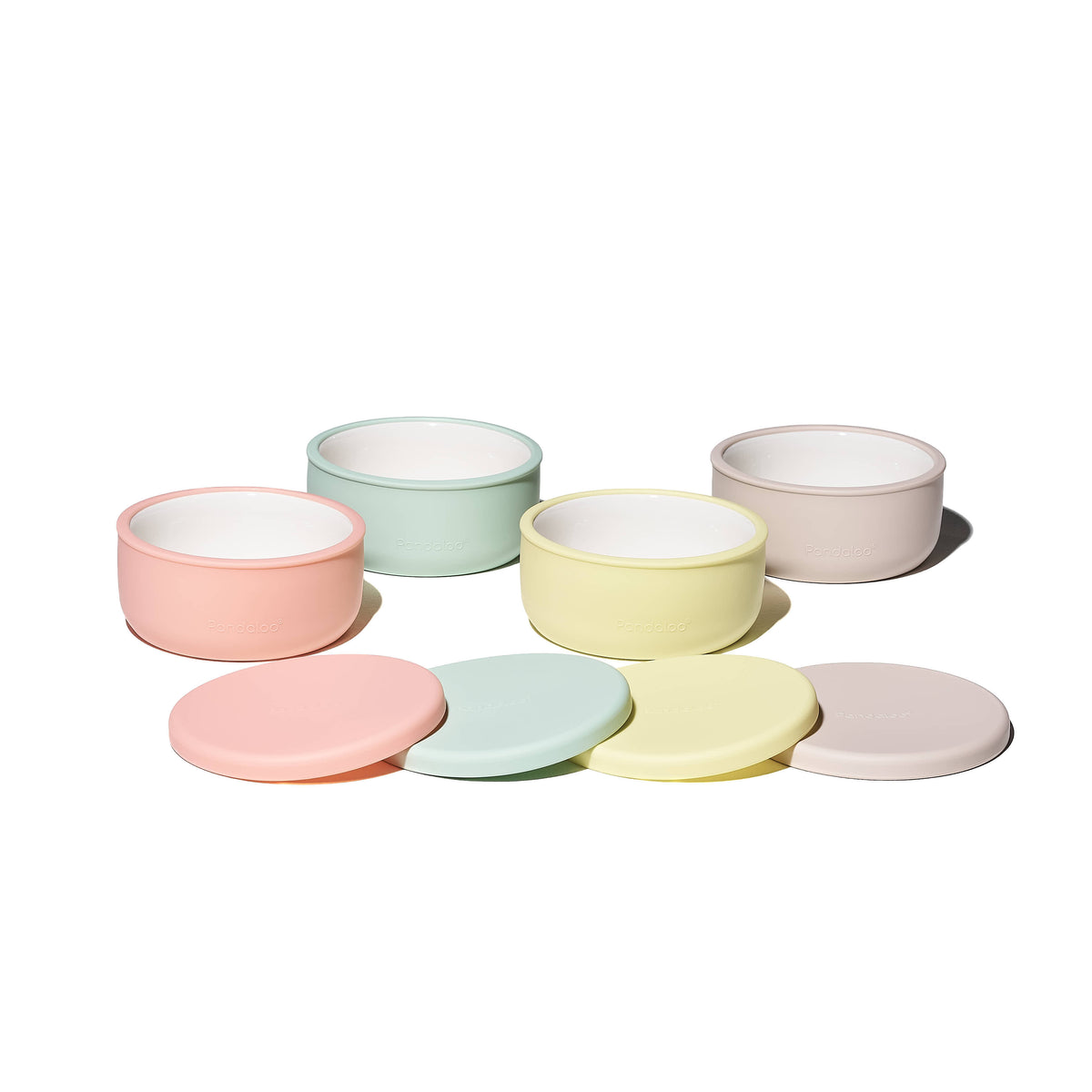 Four Pandaloo Kids porcelain bowls in Creamy Mushroom, Sweet Sage, Lime and Peach with silicone lids