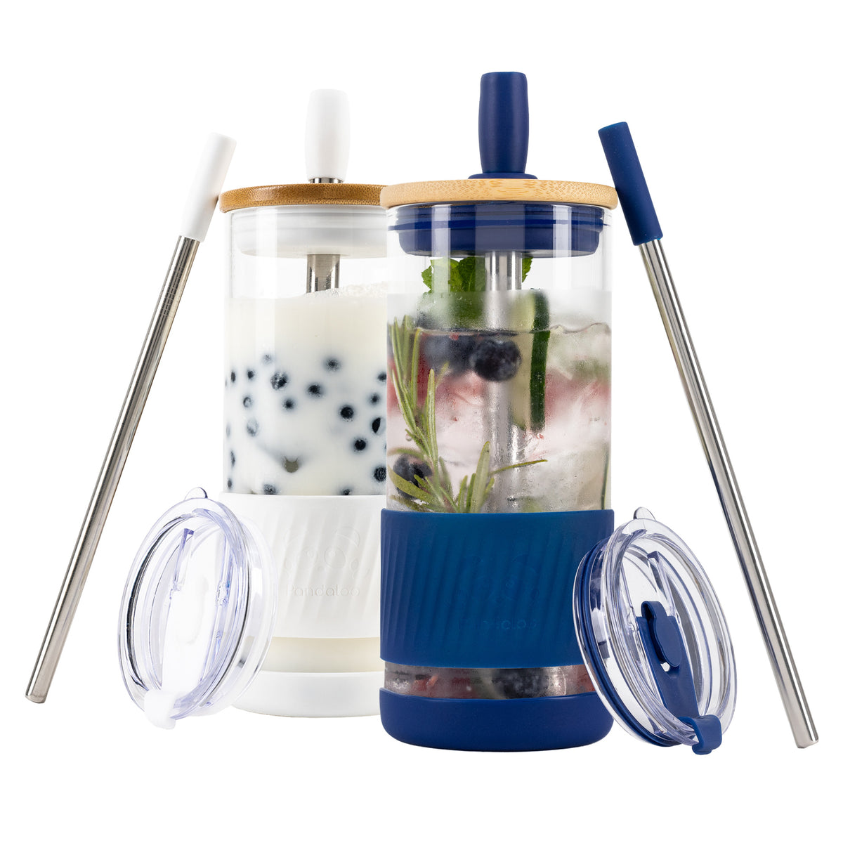 Two Pandaloo Original 20 oz glass tumblers in Galactic Blue and Coton White with bamboo lids, travel lids and stainless steel straws